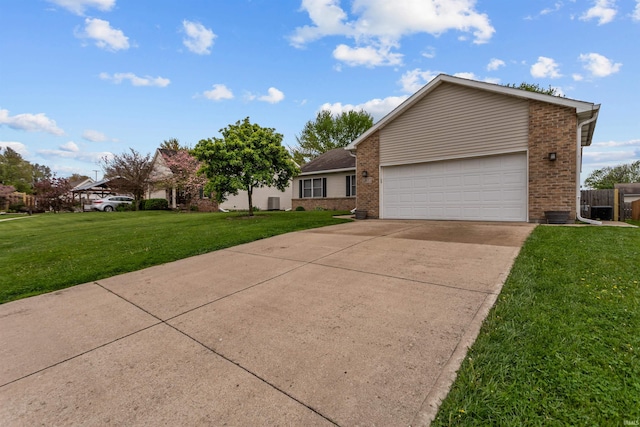 ranch-style house with concrete driveway, brick siding, a front yard, and a garage