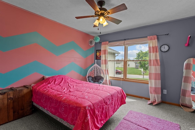 bedroom featuring baseboards, carpet flooring, a textured ceiling, and ceiling fan