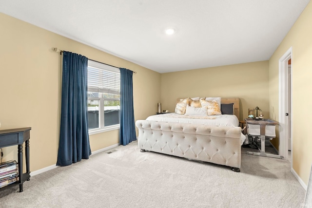 carpeted bedroom featuring visible vents and baseboards