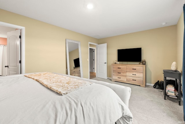 carpeted bedroom featuring baseboards