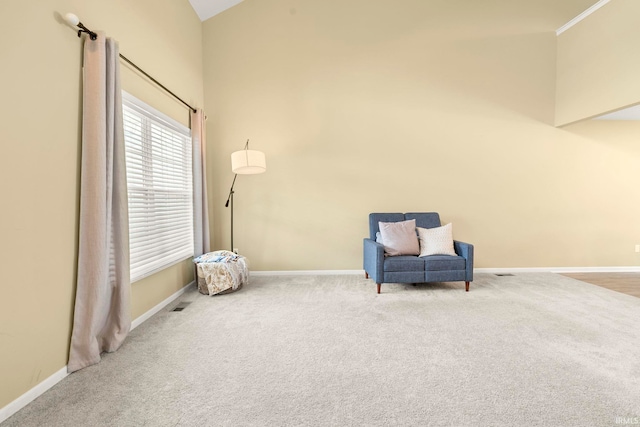 unfurnished room featuring baseboards, carpet, visible vents, and high vaulted ceiling