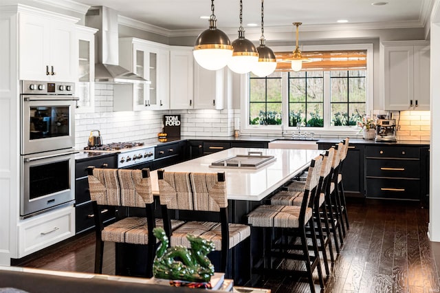 13341 Leesburg Rd, Fort Wayne, IN 46818 - kitchen featuring a sink, stainless steel appliances, wall chimney exhaust hood, and white cabinetry