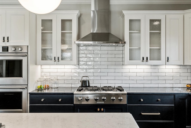 13341 Leesburg Rd, Fort Wayne, IN 46818 - kitchen featuring dark cabinetry, white cabinets, wall chimney range hood, and stainless steel appliances