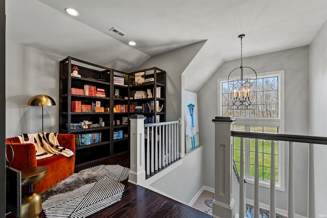 13341 Leesburg Rd, Fort Wayne, IN 46818 - living area featuring visible vents, vaulted ceiling, wood finished floors, an upstairs landing, and an inviting chandelier