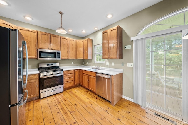 kitchen with visible vents, light countertops, light wood finished floors, and appliances with stainless steel finishes