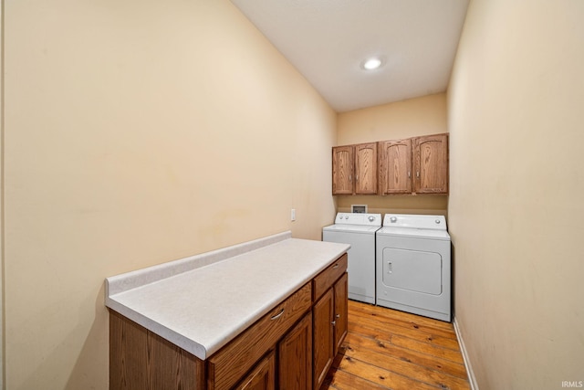 laundry area with washer and dryer, hardwood / wood-style floors, baseboards, recessed lighting, and cabinet space