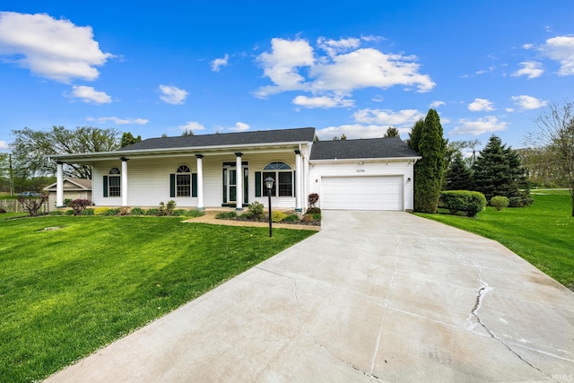 view of front of house with an attached garage, covered porch, a front yard, and concrete driveway