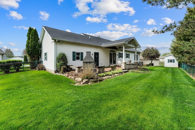 back of property featuring roof with shingles, ceiling fan, a fenced backyard, a patio area, and a lawn
