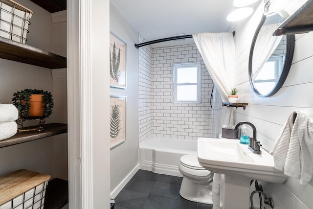 bathroom featuring shower / bathtub combination, toilet, tile patterned floors, and baseboards