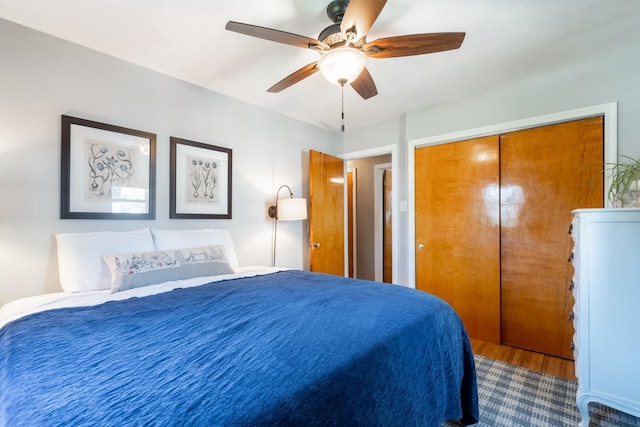 bedroom with a closet, ceiling fan, and wood finished floors