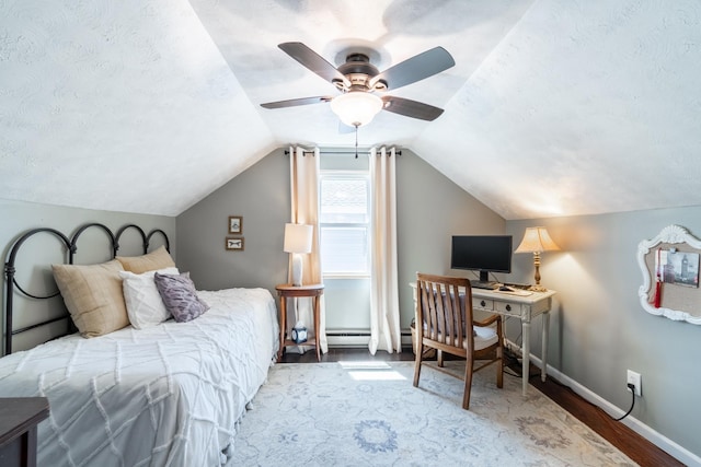 bedroom featuring baseboards, ceiling fan, wood finished floors, and lofted ceiling