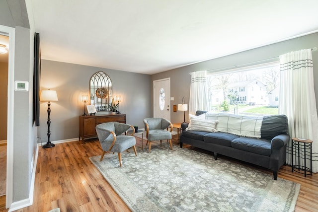 living room with light wood-type flooring and baseboards