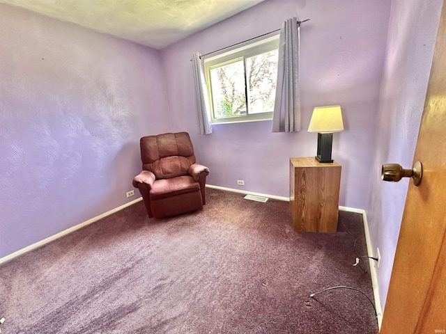 living area featuring visible vents, baseboards, and carpet floors