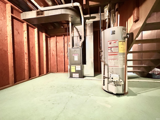 utility room with visible vents and water heater