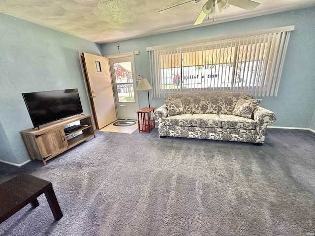 carpeted living area featuring baseboards and a ceiling fan