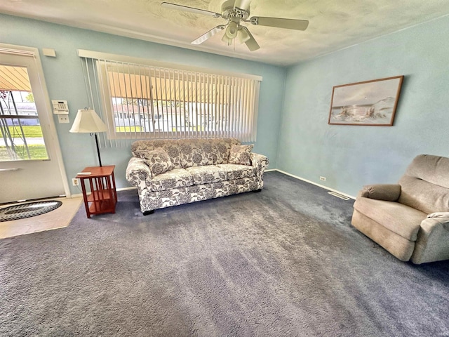 living area with carpet floors, a ceiling fan, baseboards, and visible vents