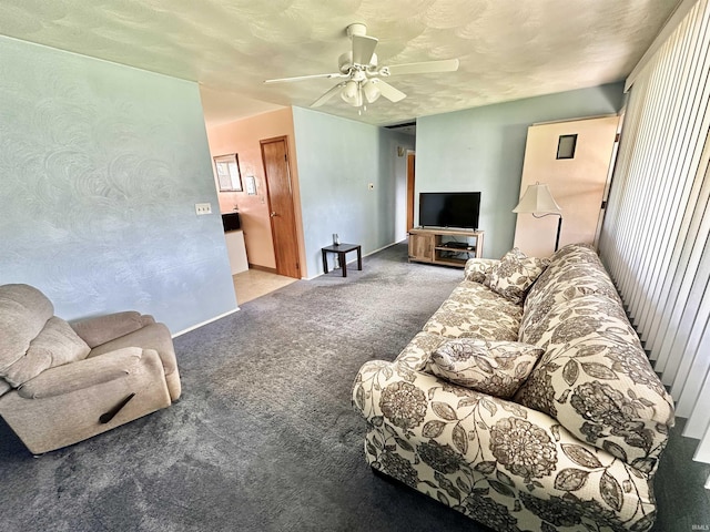 living room featuring ceiling fan, baseboards, and carpet