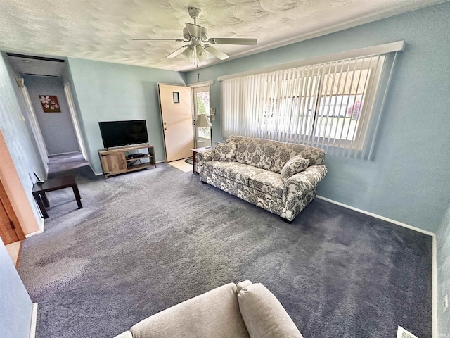 carpeted living room with a ceiling fan and baseboards