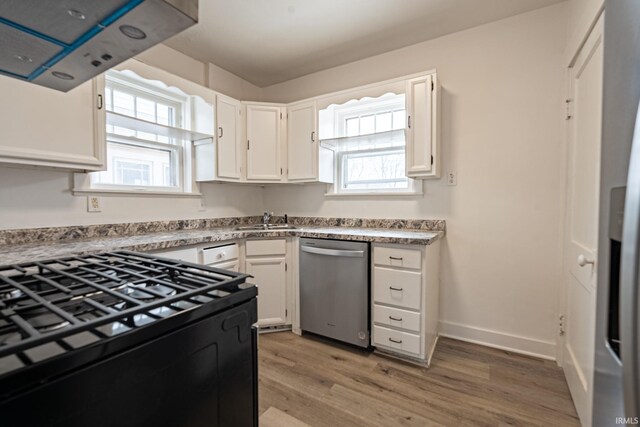 kitchen with black gas range, white cabinetry, a wealth of natural light, and dishwasher