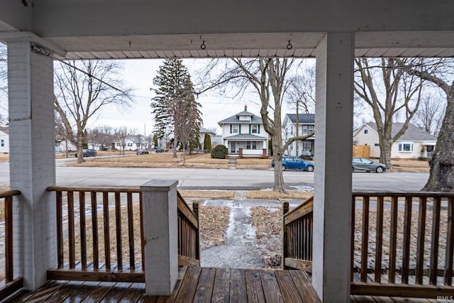 wooden terrace with a residential view and covered porch