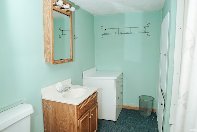 half bath featuring toilet and vanity