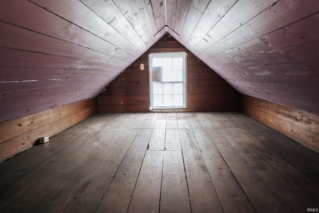 additional living space featuring wooden walls, wood ceiling, wood-type flooring, and lofted ceiling