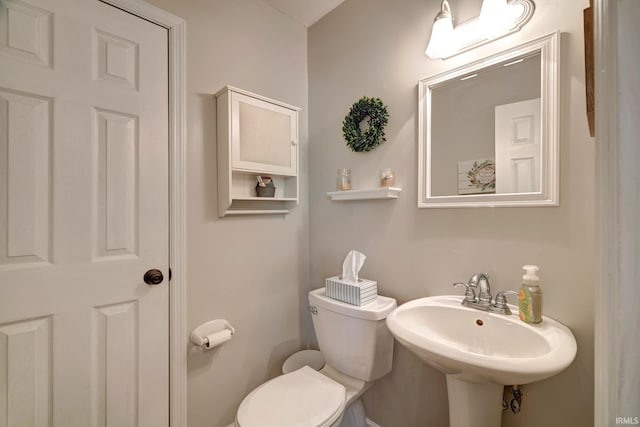 bathroom featuring toilet and a sink