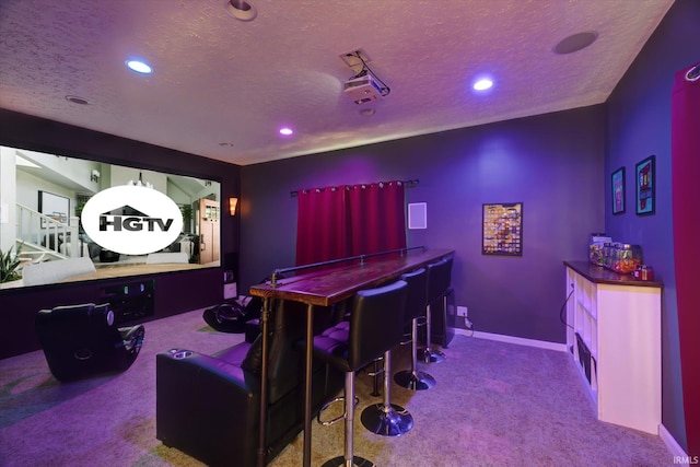 home theater room featuring carpet floors, recessed lighting, and a textured ceiling