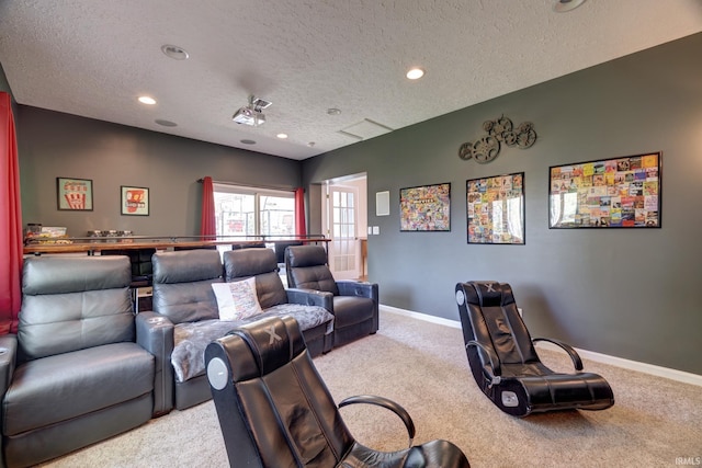 home theater room with baseboards, light carpet, recessed lighting, and a textured ceiling