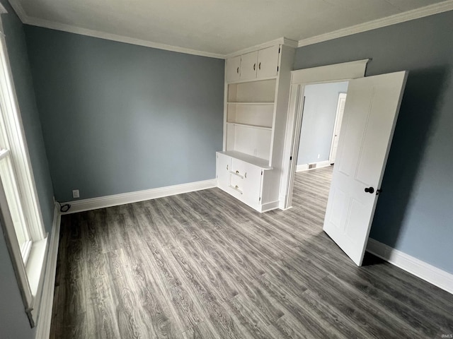 unfurnished bedroom featuring baseboards and dark wood finished floors