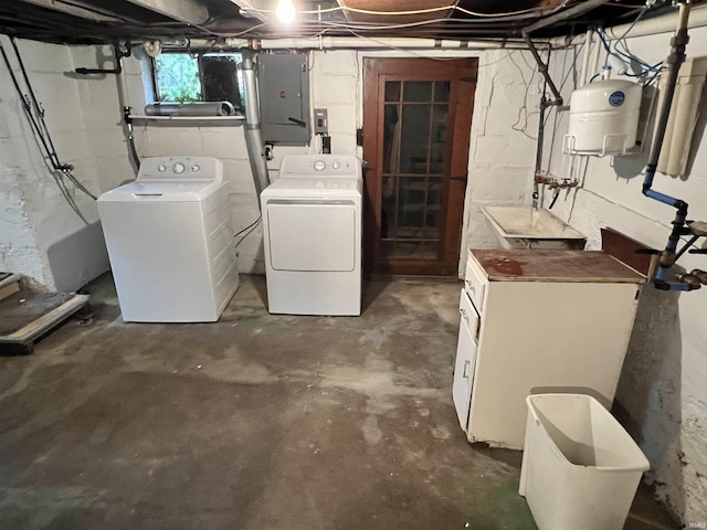 basement featuring electric panel and washer and dryer