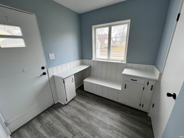 clothes washing area with wood finished floors