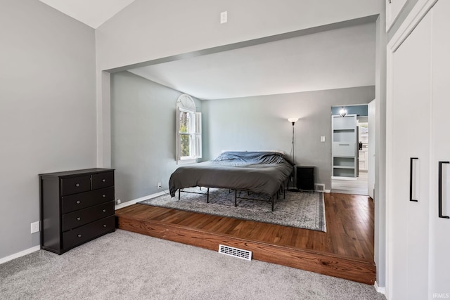 706 Ruse St, North Manchester, IN 46962 - bedroom with visible vents, carpet flooring, baseboards, and wood finished floors