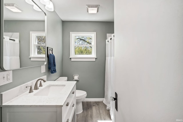 706 Ruse St, North Manchester, IN 46962 - bathroom with vanity, toilet, baseboards, wood finished floors, and visible vents