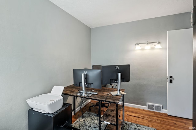 706 Ruse St, North Manchester, IN 46962 - home office with baseboards, wood finished floors, and visible vents