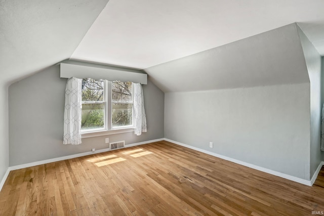706 Ruse St, North Manchester, IN 46962 - additional living space featuring baseboards, lofted ceiling, wood finished floors, and visible vents