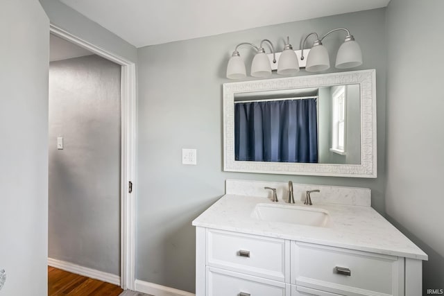 706 Ruse St, North Manchester, IN 46962 - bathroom featuring vanity, baseboards, and wood finished floors
