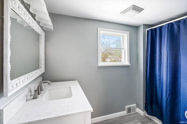706 Ruse St, North Manchester, IN 46962 - full bath featuring baseboards, visible vents, wood finished floors, and vanity