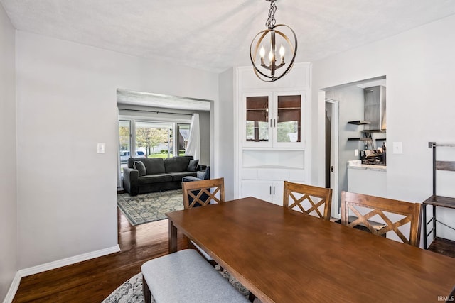 706 Ruse St, North Manchester, IN 46962 - dining area with an inviting chandelier, baseboards, and dark wood-style floors