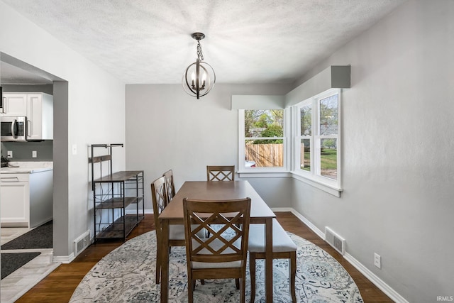 706 Ruse St, North Manchester, IN 46962 - dining area with visible vents, dark wood-style flooring, and baseboards