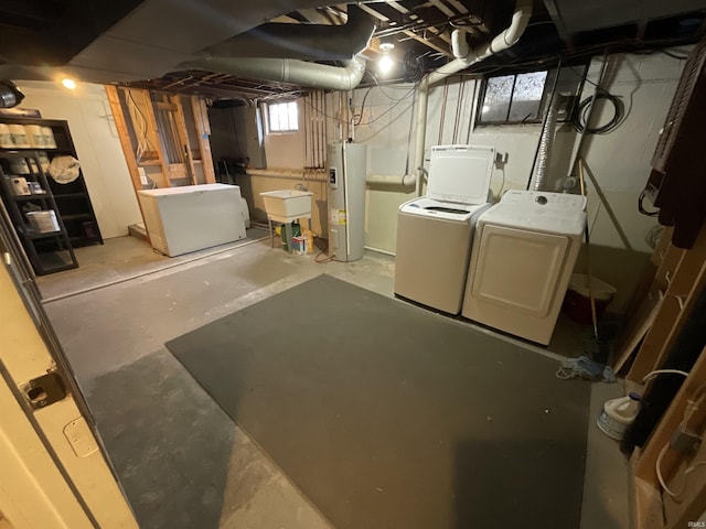 below grade area featuring water heater, fridge, independent washer and dryer, and a sink