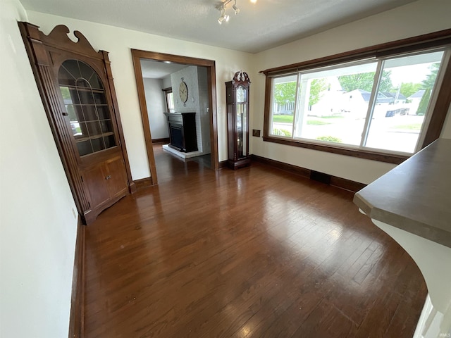dining room featuring baseboards and dark wood-style flooring