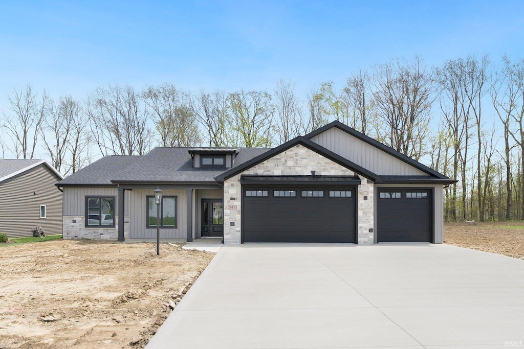 348 N Sweet Briar Ct, Columbia City, IN 46725 - view of front facade featuring concrete driveway, an attached garage, and a shingled roof