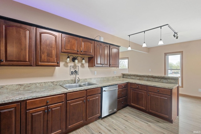 kitchen with light wood-type flooring, a sink, a healthy amount of sunlight, and dishwasher