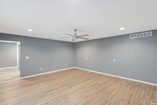 empty room featuring visible vents, baseboards, recessed lighting, light wood-type flooring, and a ceiling fan