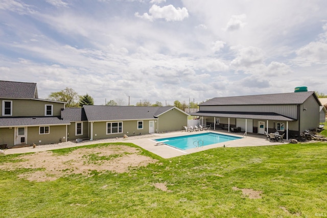 outdoor pool featuring a patio area and a yard