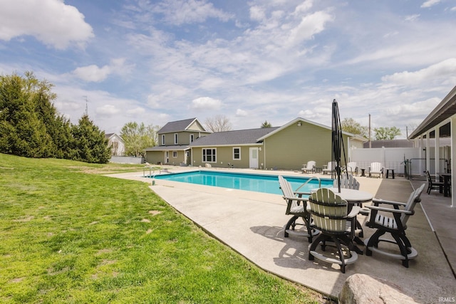 view of swimming pool featuring a lawn, a patio, and a fenced in pool