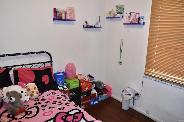 bedroom with baseboards and wood finished floors