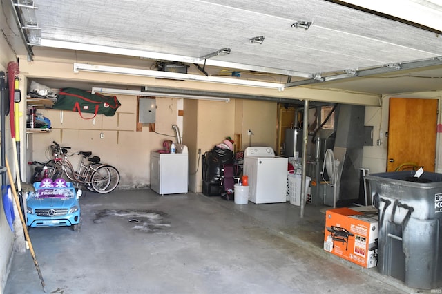 garage featuring washer / clothes dryer, water heater, and electric panel