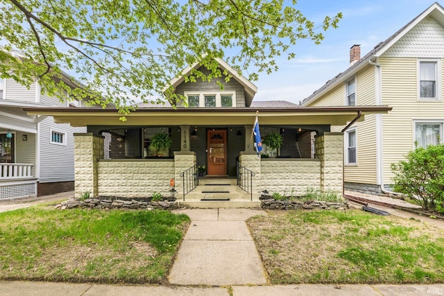 view of front of house with a porch and stone siding
